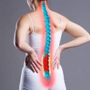 Pain in the spine, woman with backache on gray background